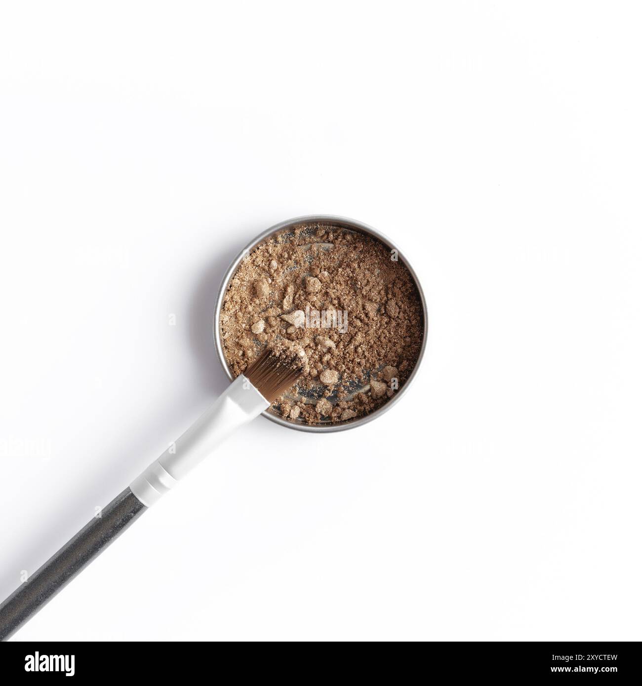 Light brown face shadow in container and eye shadow or make-up brush. Makeup concept flat lay on white background Stock Photo