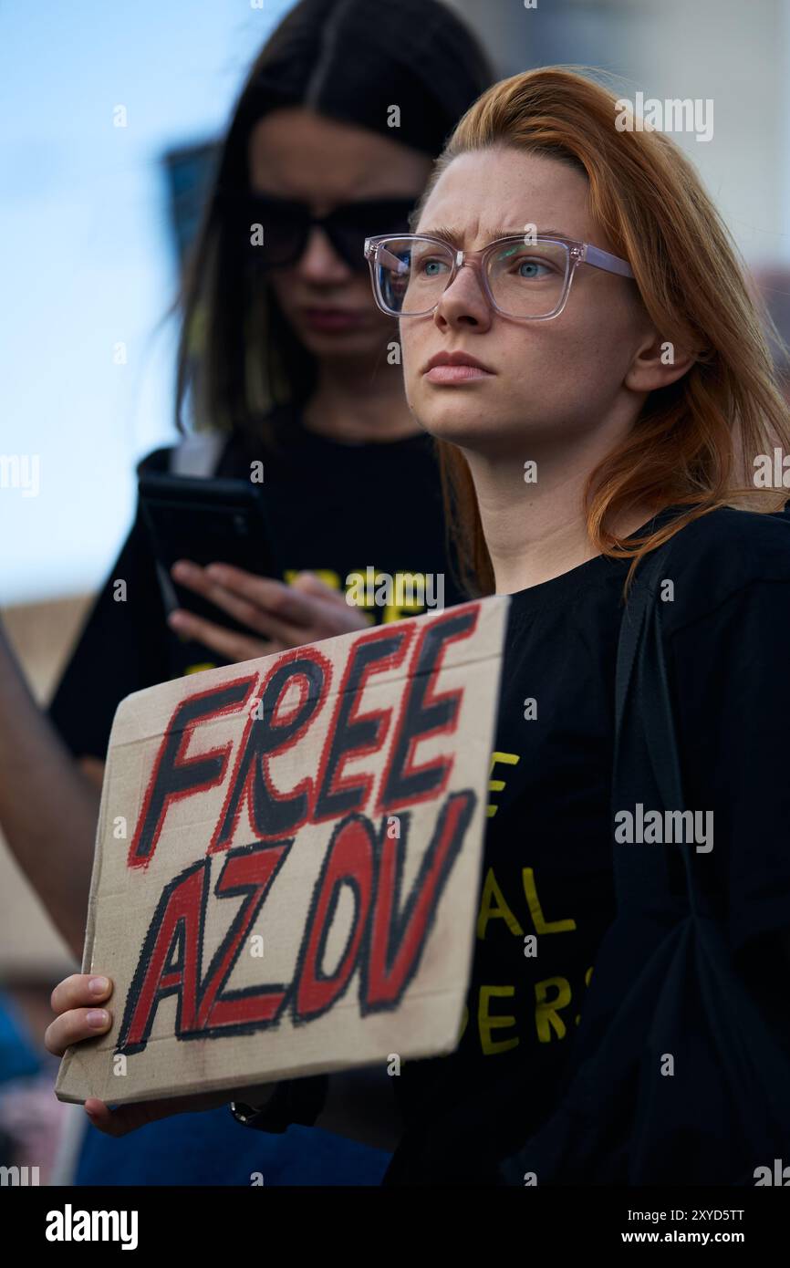 Sad Ukrainian activist with a sign Free Azov on a public rally in Kyiv ...
