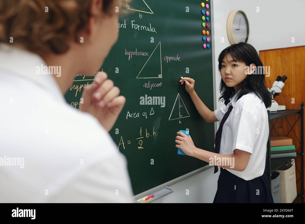 Student Engaging in Geometry Class Discussion at Board Stock Photo