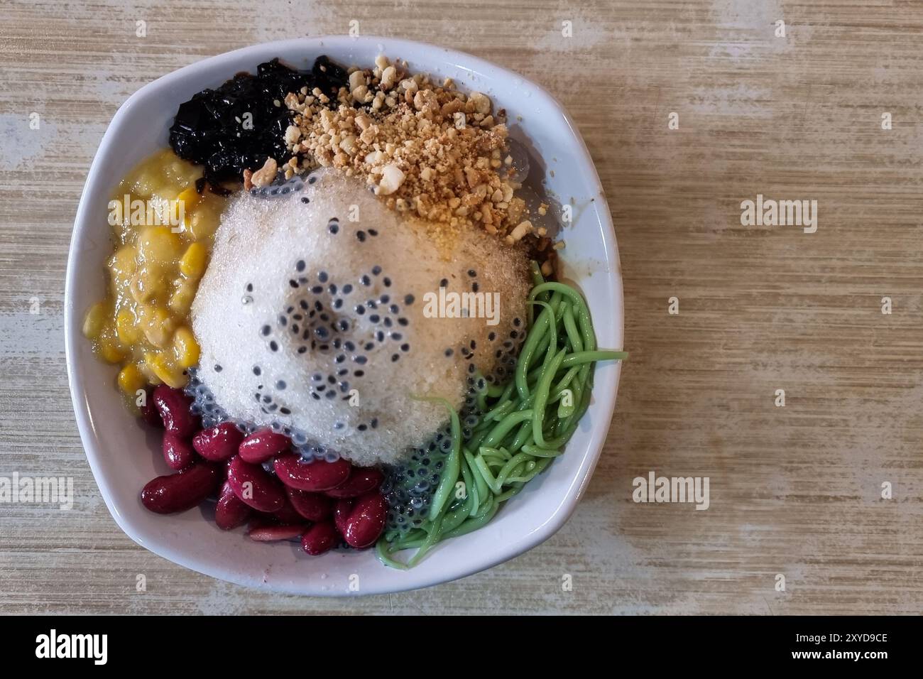 Overhead view of authentic ice kacang or shaved ice with ingredients like red beans, cendol and sweet corn is popular traditional sweet delicacy in Ma Stock Photo