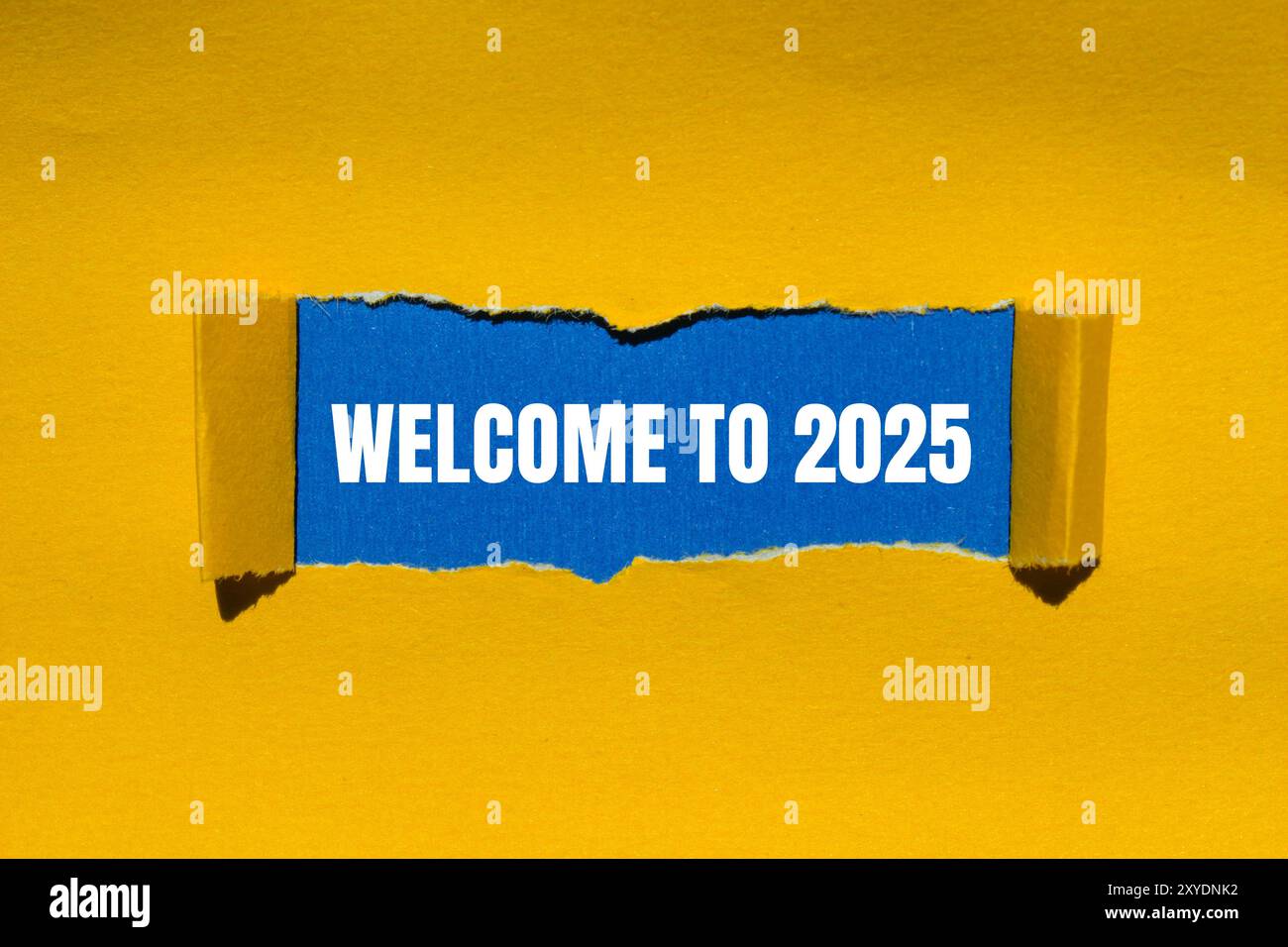 Welcome To 2025 Message Written On Ripped Torn Yellow Paper With Blue Welcome To 2025 Message Written On Ripped Torn Yellow Paper With Blue