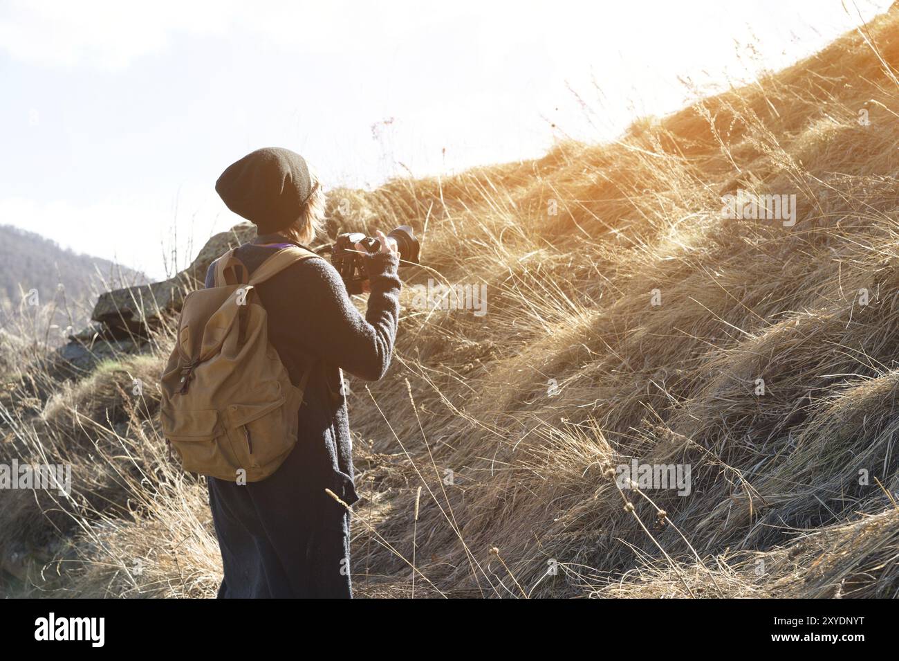 Woman hipster-photographer with dslr camera. Stylish girl in sunglasses with a camera on the nature Stock Photo