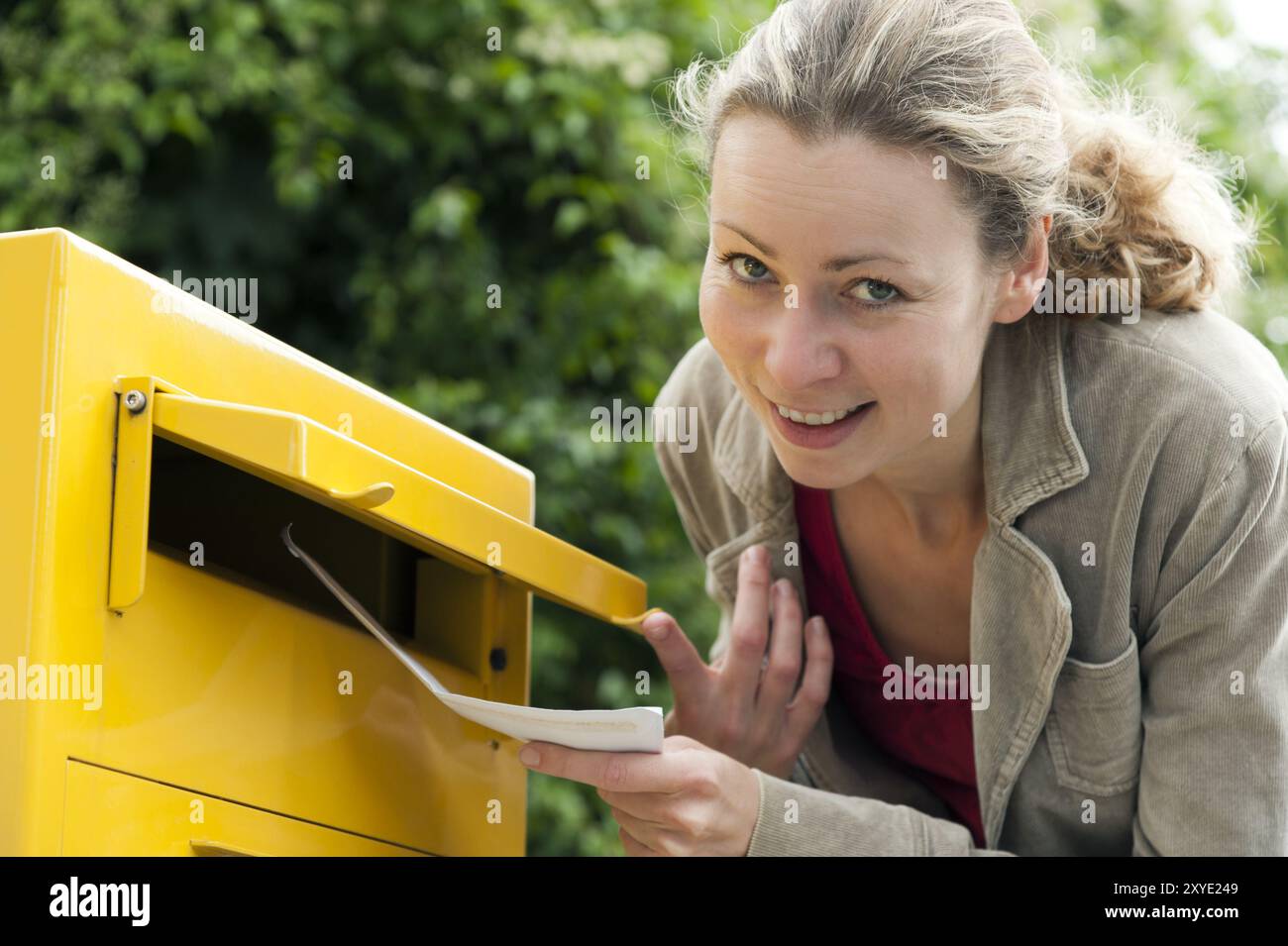 Young smiling woman postbox hi-res stock photography and images - Alamy