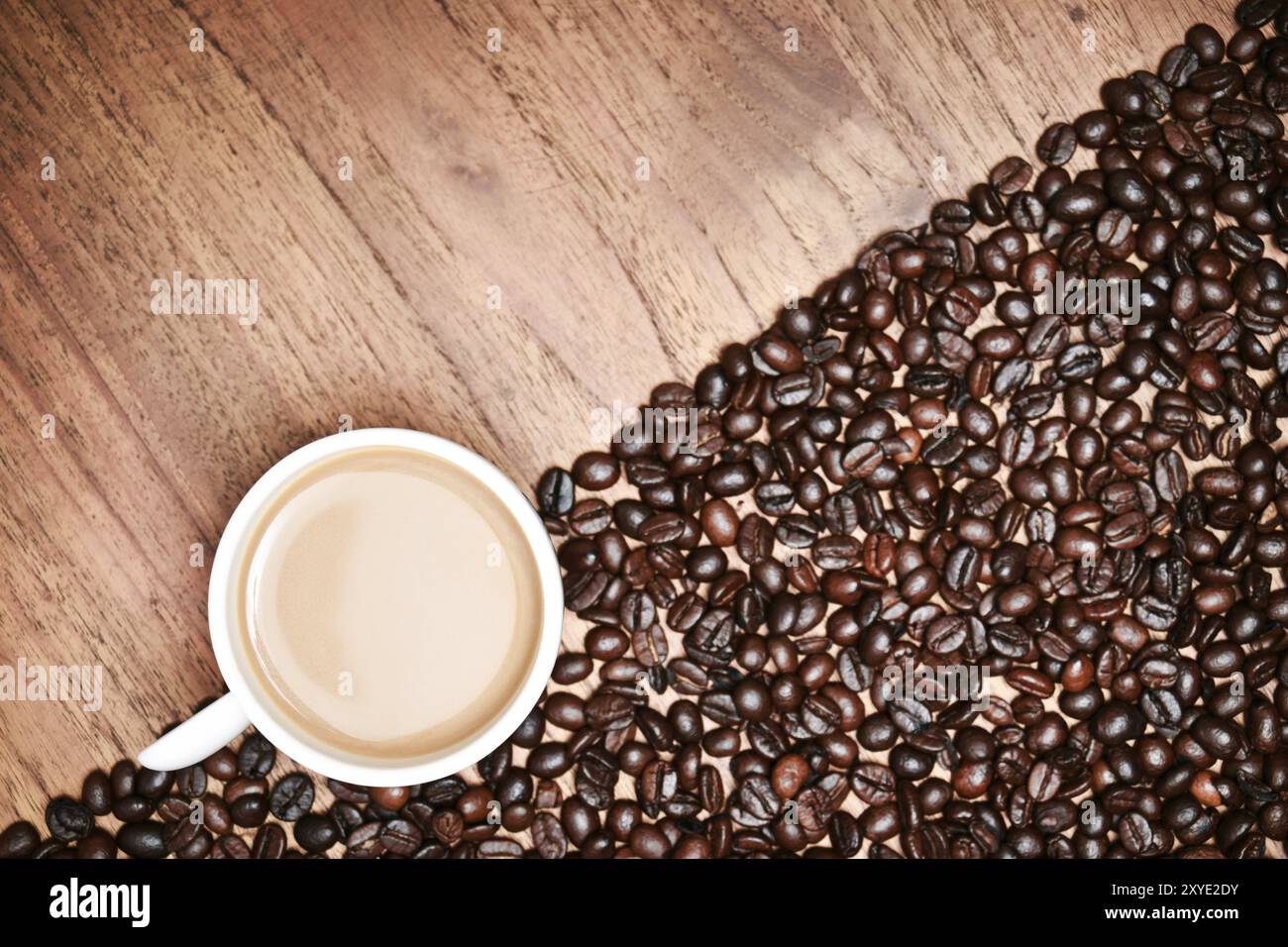 Coffee cup and coffee beans on teak wooden table, vintage Stock Photo ...