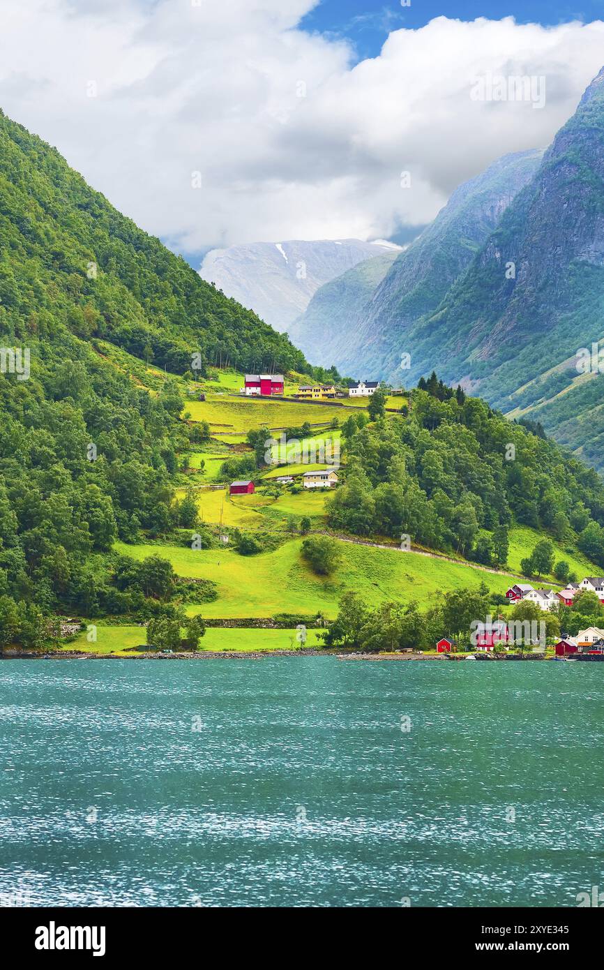 norwegian-village-landscape-with-turquoise-fjord-water-mountains-and