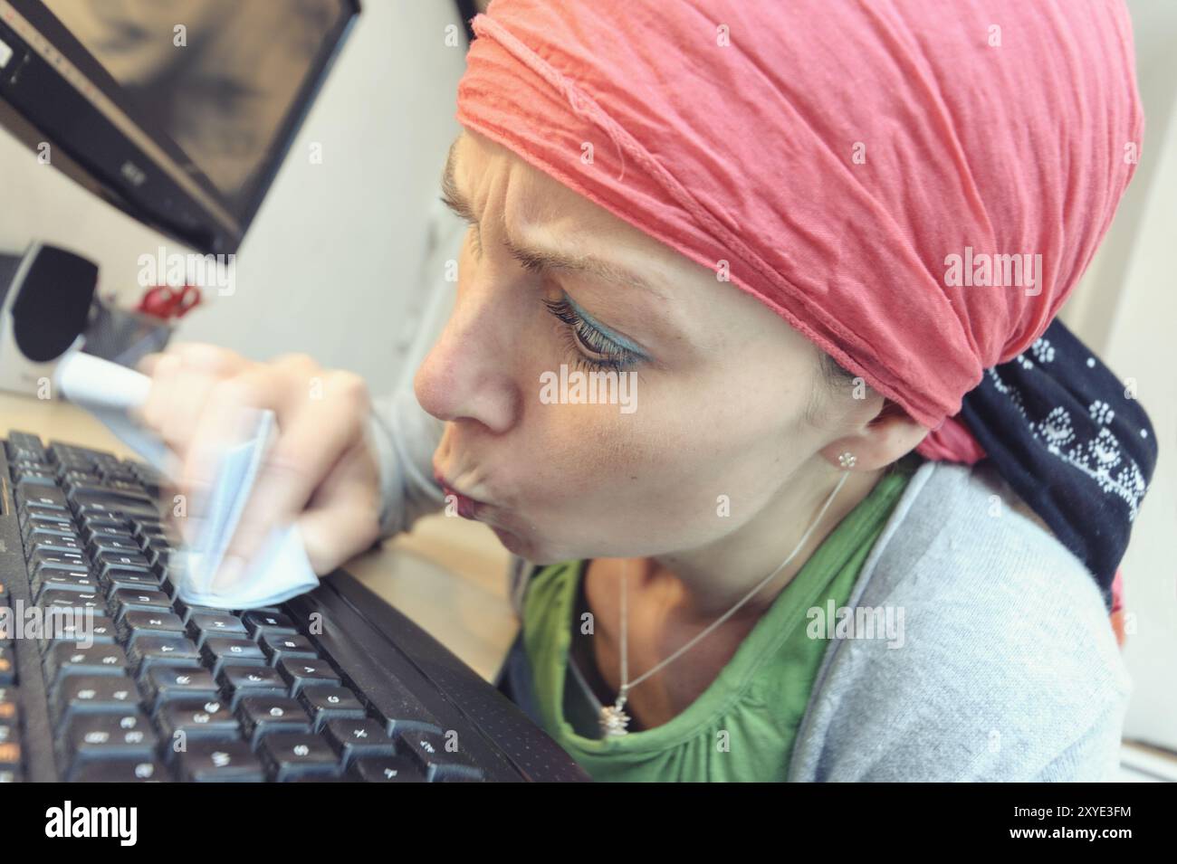 Peering Lady Computer Cleaning lady cleaning the keyboard of a PC Stock Photo - Alamy