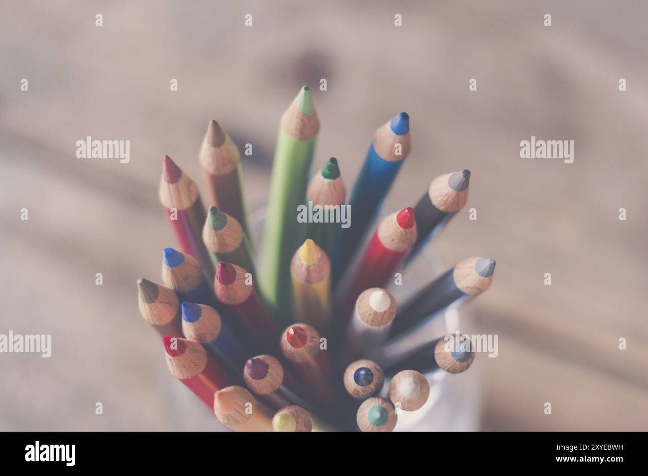 Colored pencils in a can on rustic wooden table Stock Photo