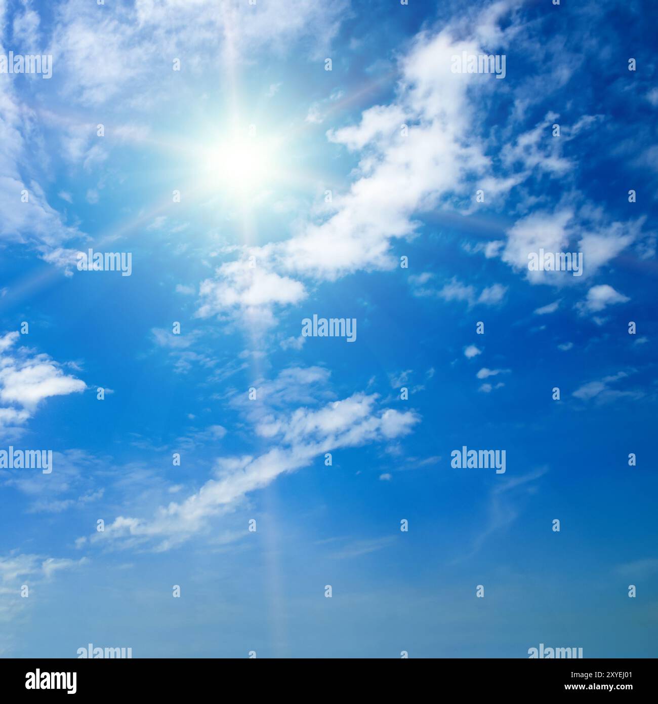 Blue sky with white clouds and bright sun Stock Photo - Alamy