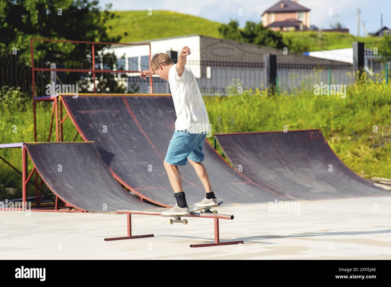 The boy skating catches the balance in the manual and slides on the ...