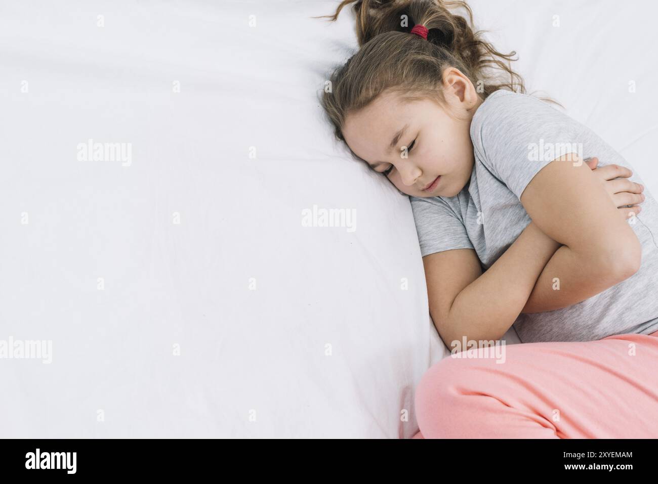 Close up girl sleeping white bed with pain Stock Photo - Alamy
