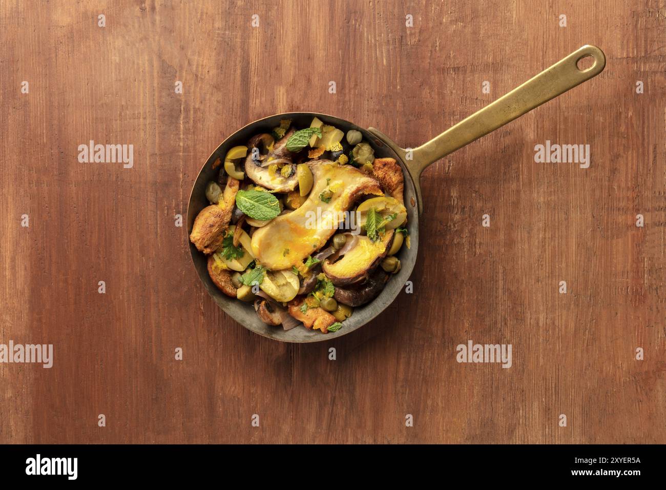 A photo of a rustic mushrooms and olives saute with mint, shot from ...