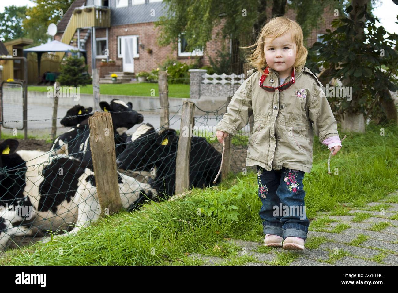 Little girl at a cow pasture Stock Photo - Alamy