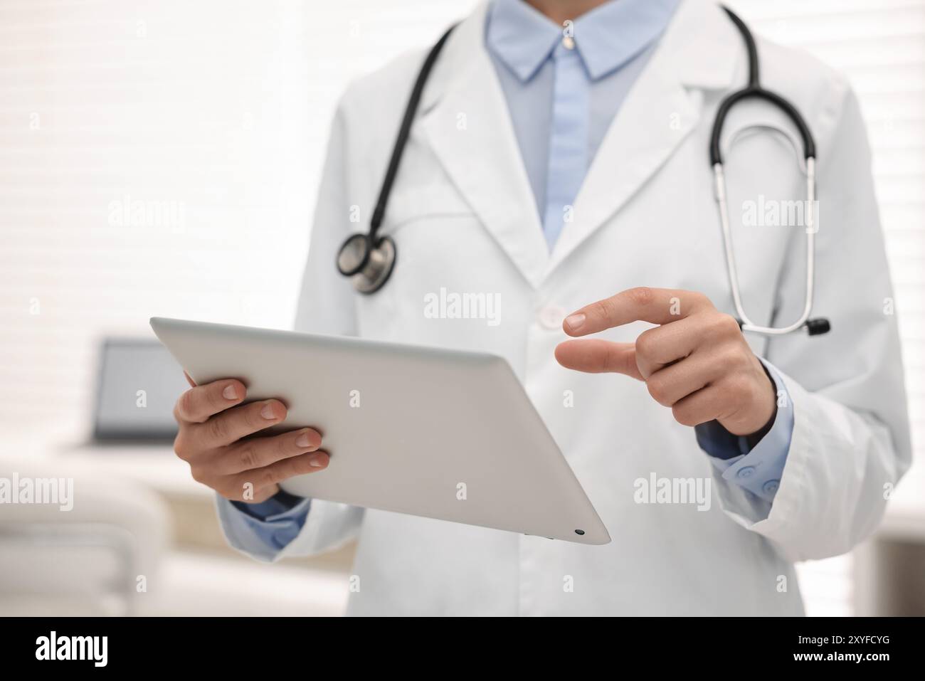 Doctor using tablet in hospital, closeup view Stock Photo