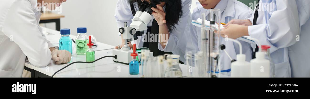 Conducting Experiment in Science Laboratory with Students Stock Photo