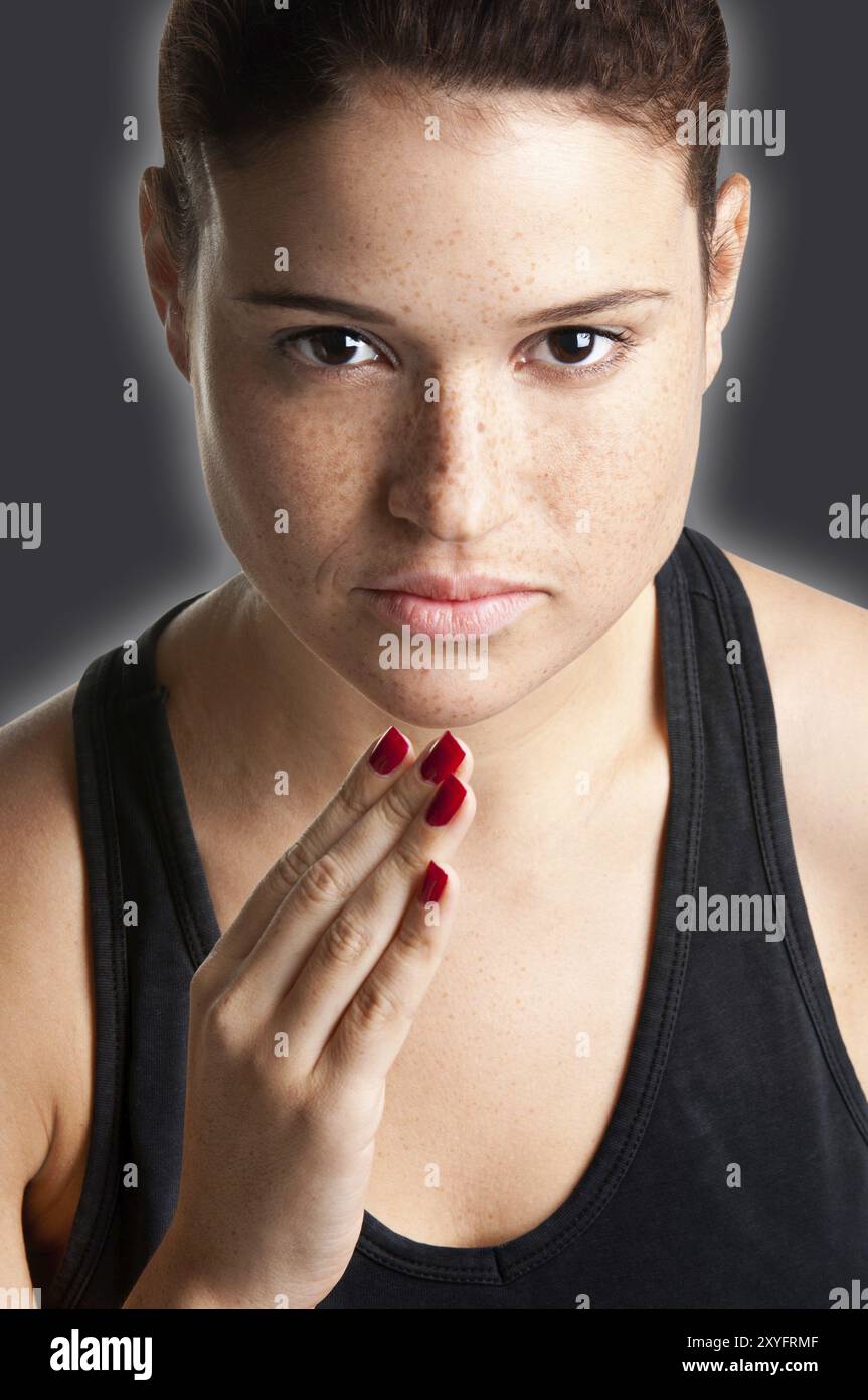 Close up portrait of a young fit woman jogging in a dark background Stock Photo