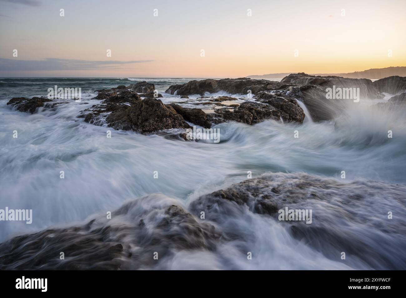 Waves washing over rocks by the sea, long exposure, coastal landscape ...