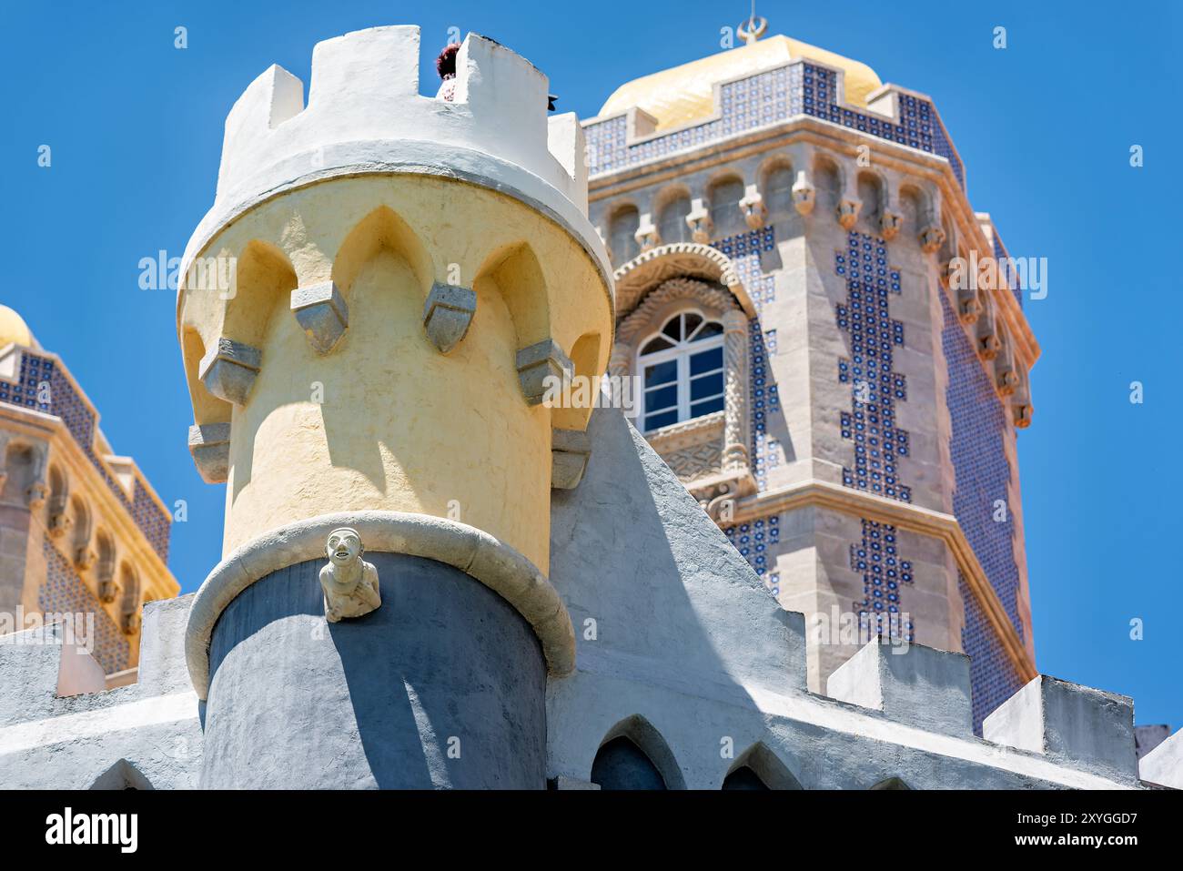 Pena Palace Architecture Sintra Portugal // SINTRA, Portugal — The vibrant and eclectic exterior architecture of Pena Palace, showcasing its blend of Romanticist, Moorish, and Neo-Manueline styles. The palace's colorful facades, ornate details, and whimsical elements epitomize 19th-century Romantic architecture and King Ferdinand II's vision of a fairytale castle. Stock Photo