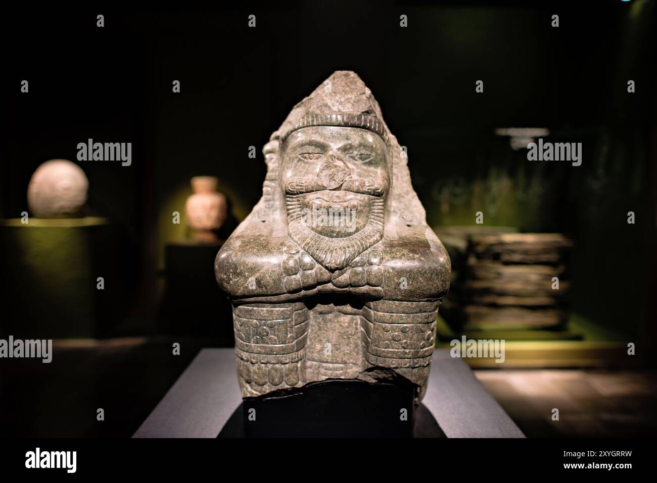 MEXICO CITY, Mexico — A sculpture representing Xiuhtecuhtli, the Aztec god of fire, discovered during archaeological excavations on Cinco de Mayo Avenue. This ancient artifact provides insights into Aztec religious beliefs and their complex understanding of the cosmos. Stock Photo