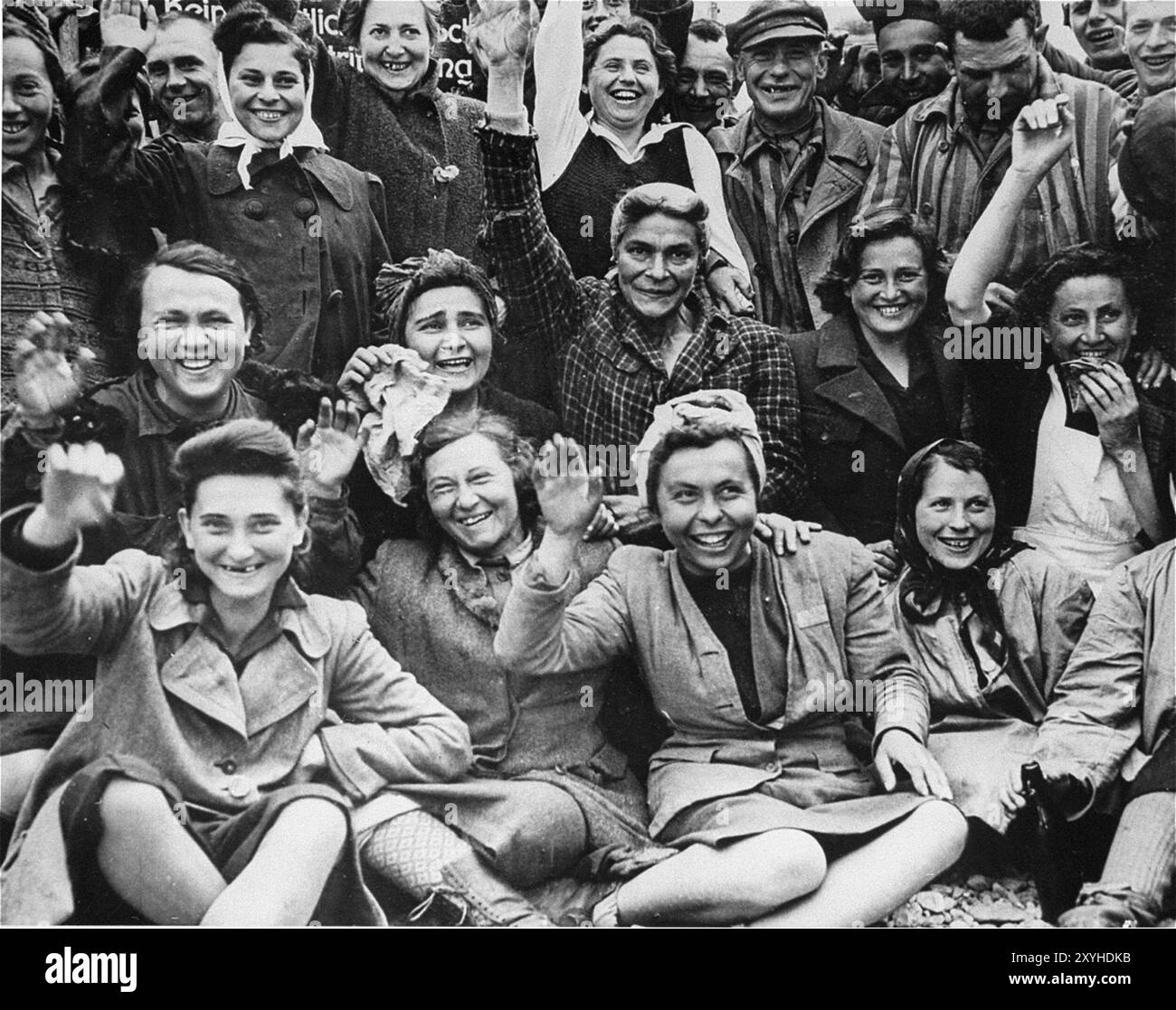 Female prisoners at Dachau wave to their liberators. Dachau was the first nazi concentration camp, opening on 22 March 1933 (just 7 weeks after Hitler came to power). Although it was a forced labour camp and there were no gas chambers there, brutality and violent punishments were the norm. There were 32000 documented deaths there and many thousands more undocumented. The main camp (Dachau had 100 sub-camps) was liberated by the US Army on 29th April 1945. The photo is dated 4th May 1945, five days after liberation. The photo is from 29th April 1945, the day of liberation Stock Photo