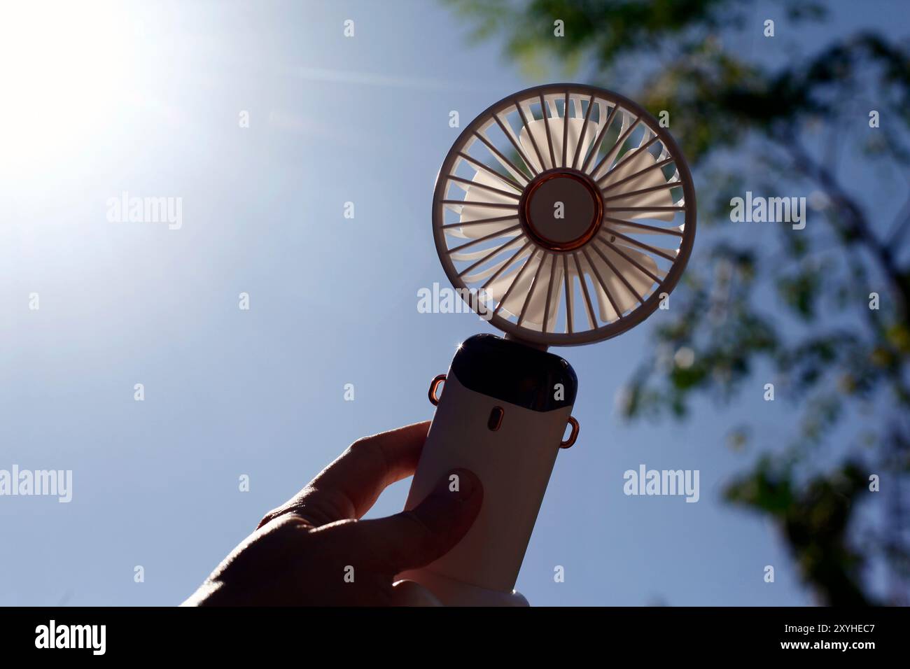 People Using Handheld Fan Photo of hand holding a portable rechargeable electric fan Stock Photo ...