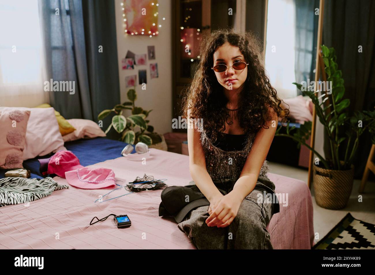 Portrait of Young Woman Posing in Cozy Bedroom Setting Stock Photo