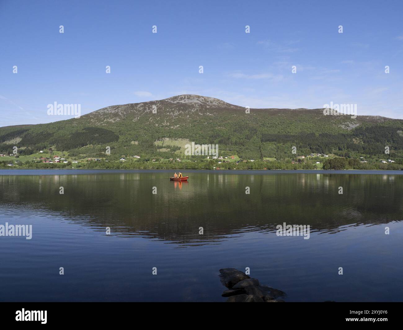 Two anglers in a boat on the Hjorungdalsvatnet in Norway Stock Photo