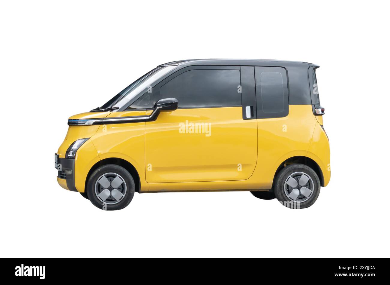 Side view of mini or small yellow electric car is isolated on white background with clipping path. Stock Photo