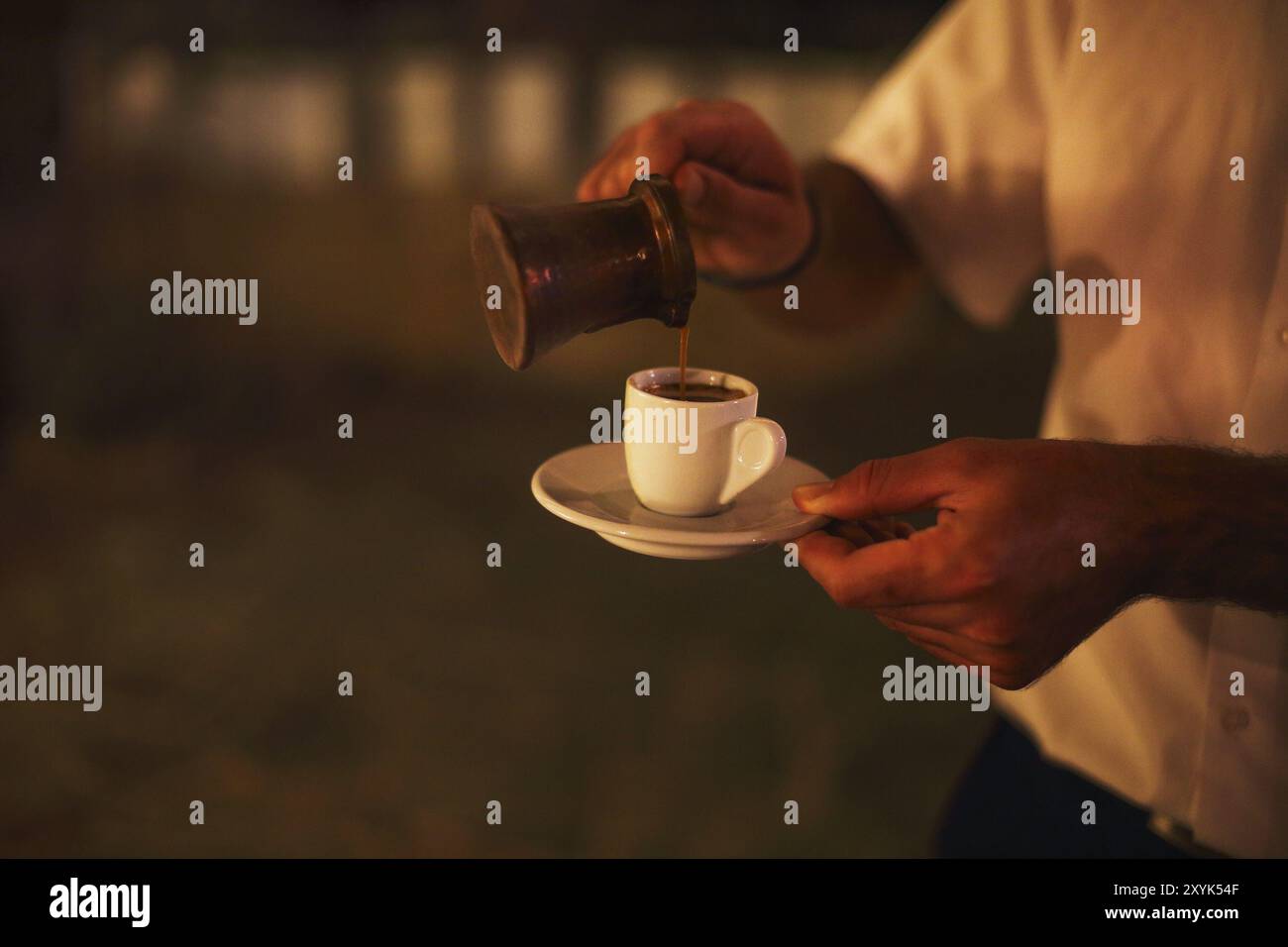 Man making traditional arabic coffee Stock Photo