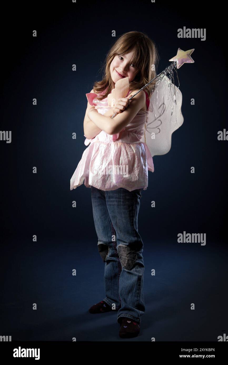 Little girl dressed up as a fairy with a magic wand Stock Photo - Alamy