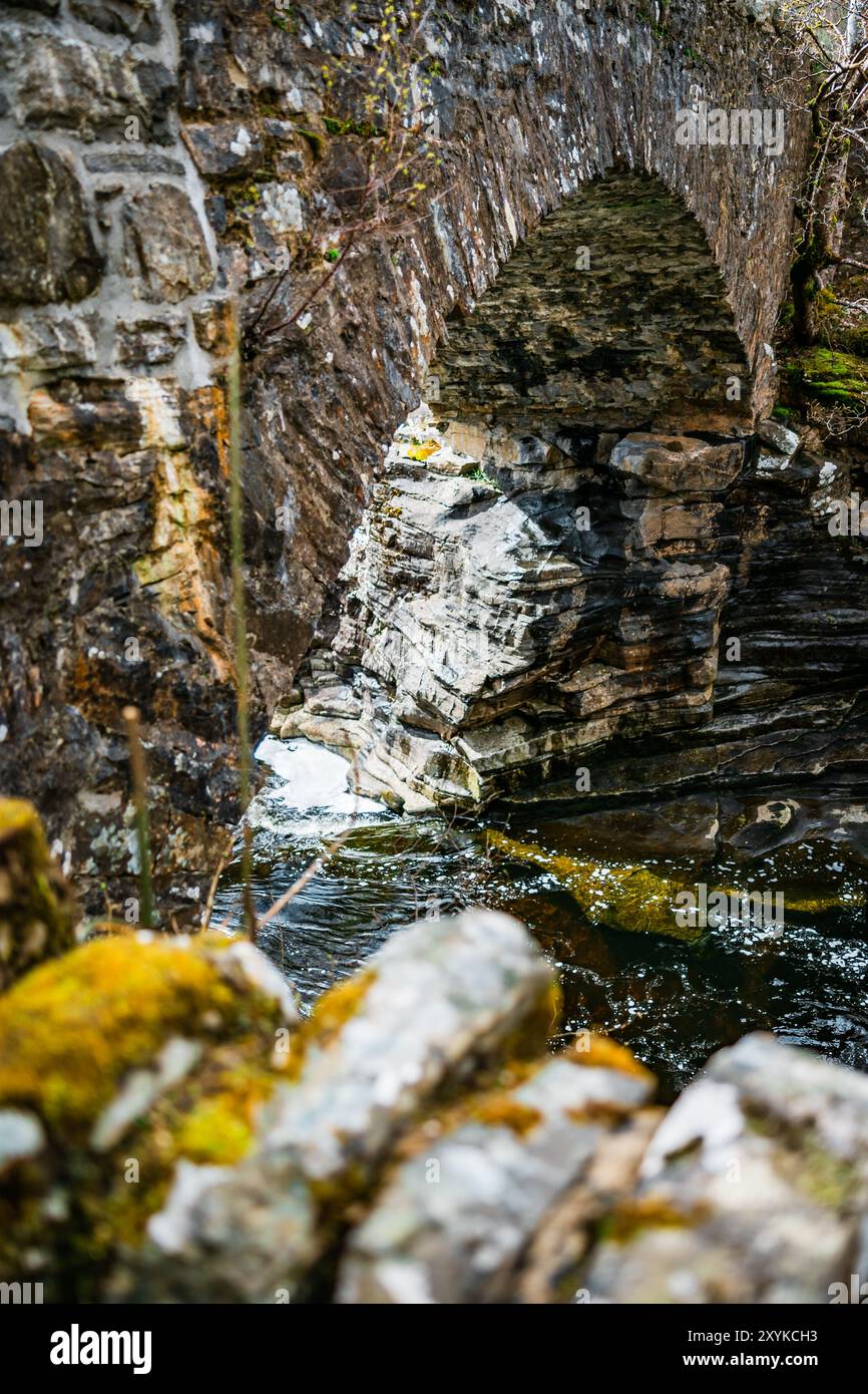 River Running Under Old Stone Bridge Stock Photo