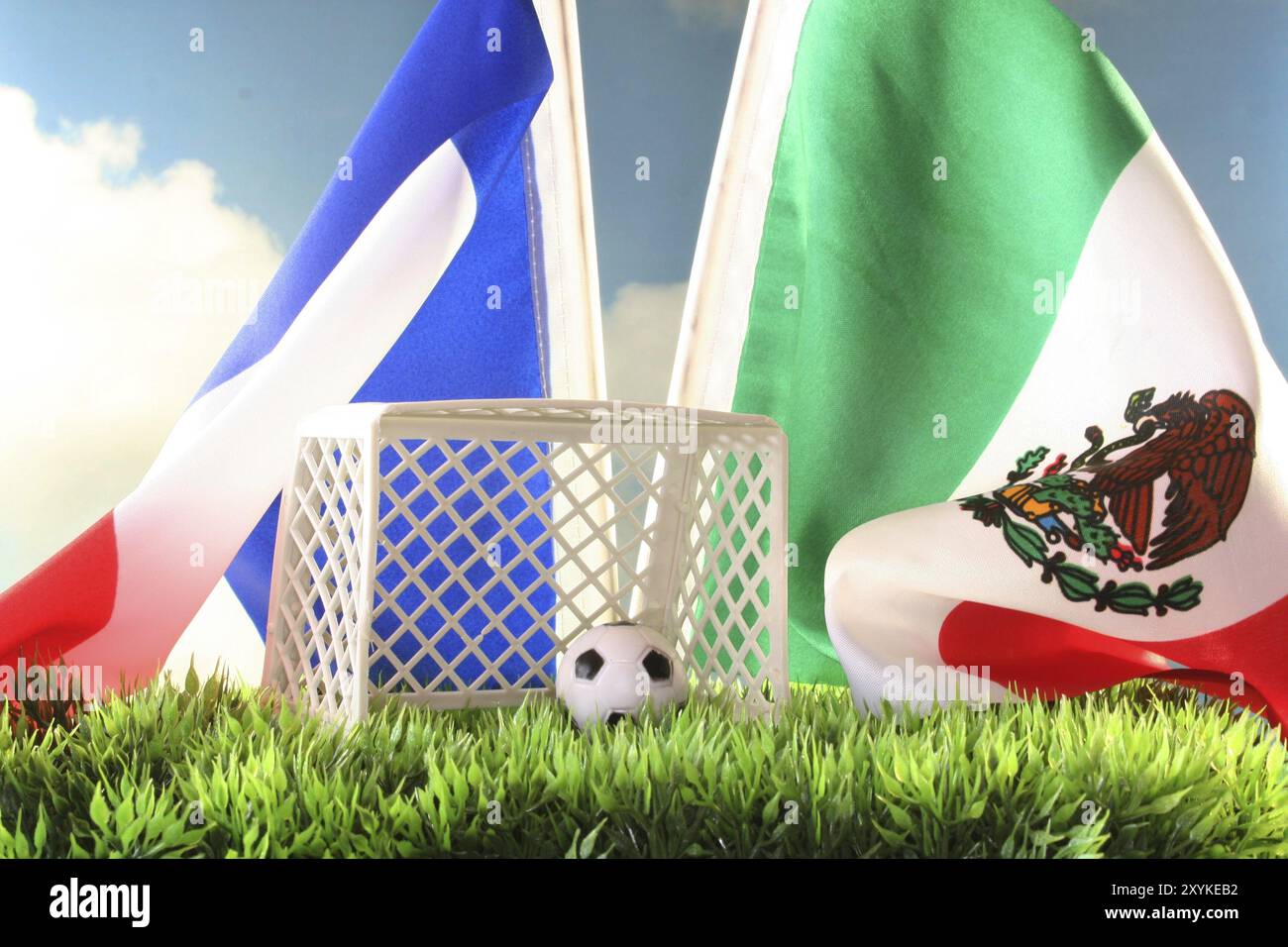 Flag of France and Mexico with football goal and football in a meadow Stock Photo