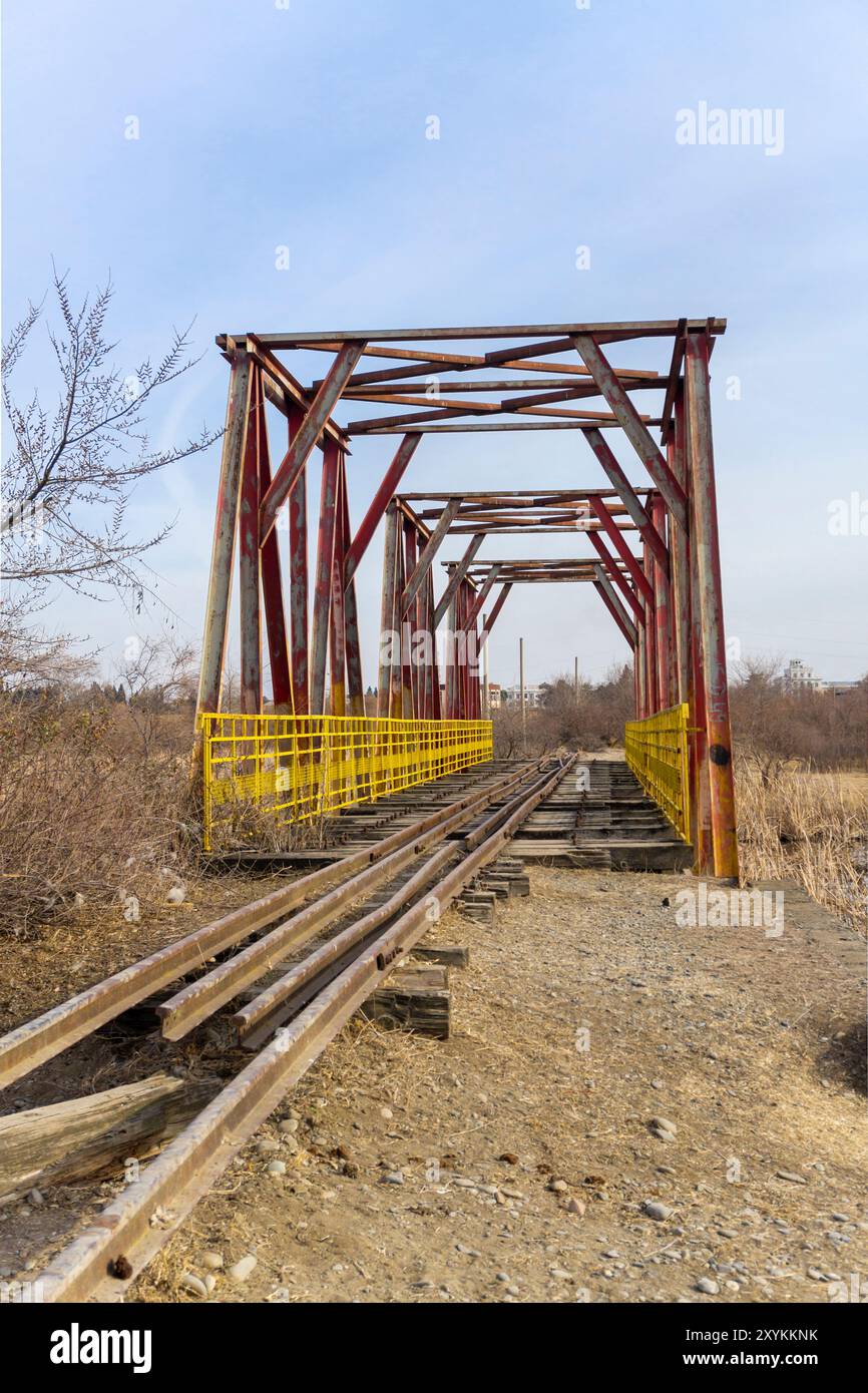 Old rusty rails stretching into perspective lead to a metal railway ...