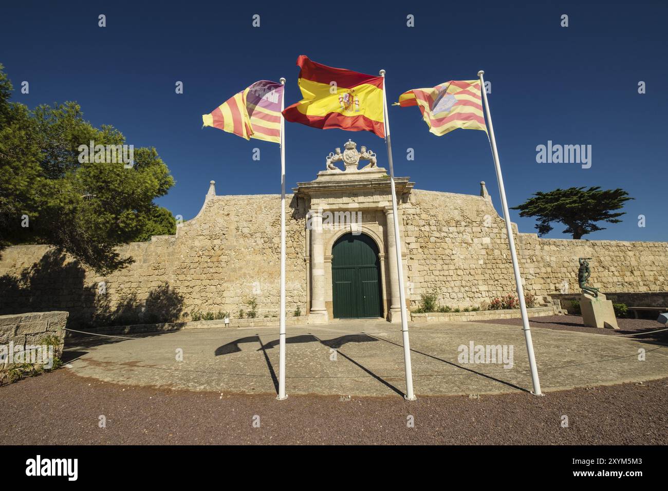 Spanish and Balearic flags, Puerta de los Leones, Main Entrance of the island of Lazareto, former military hospital, Illa del Llatzeret, interior of t Stock Photo