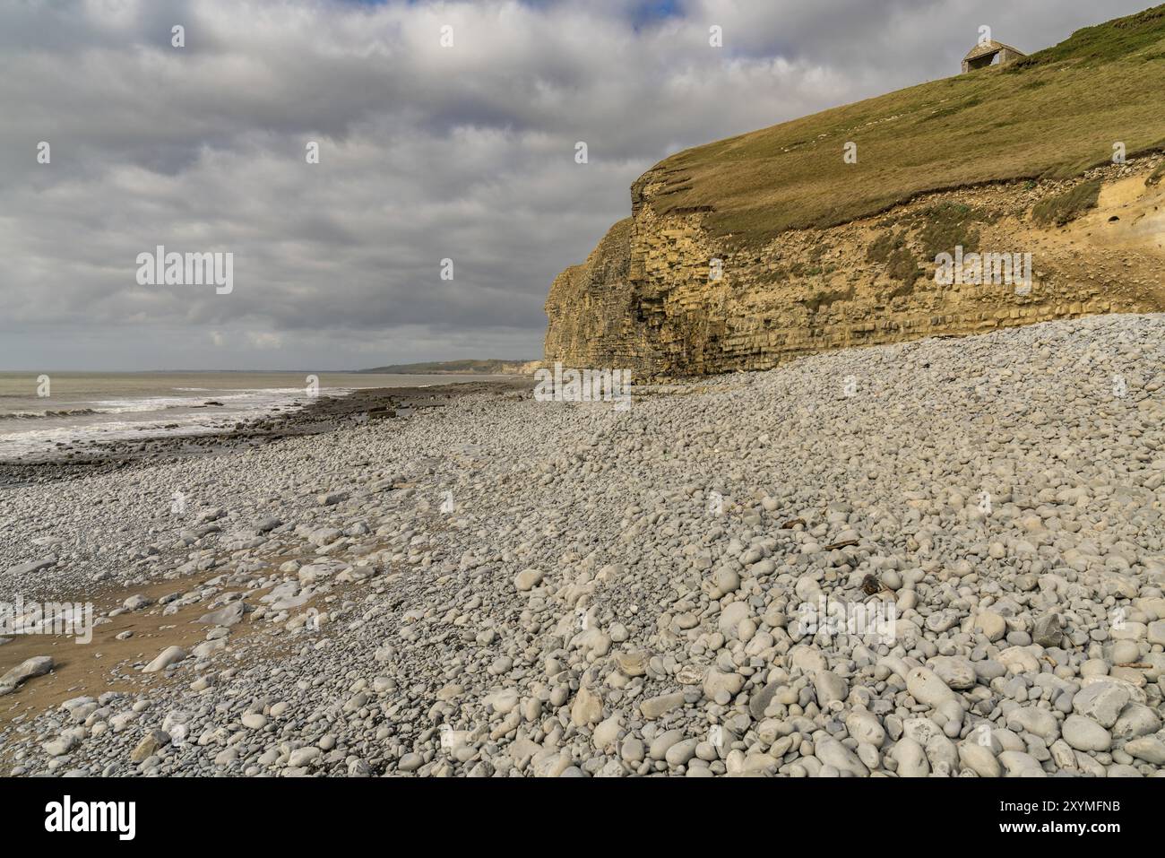 Stones and cliff on a cloudy day at Monknash Beach in South Glamorgan, Wales, UK Stock Photo