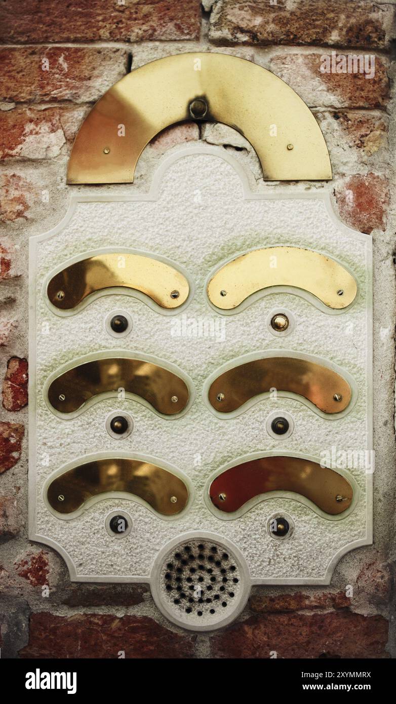 An intercom doorbell panel on the brick wall Stock Photo
