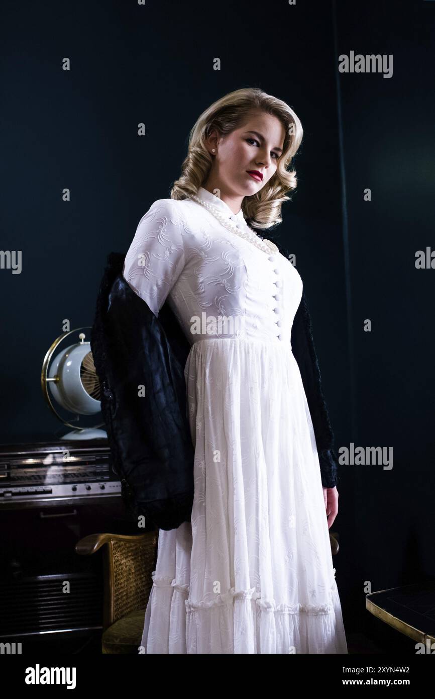 Blonde woman dressed in the style of the forties in a bar Stock Photo