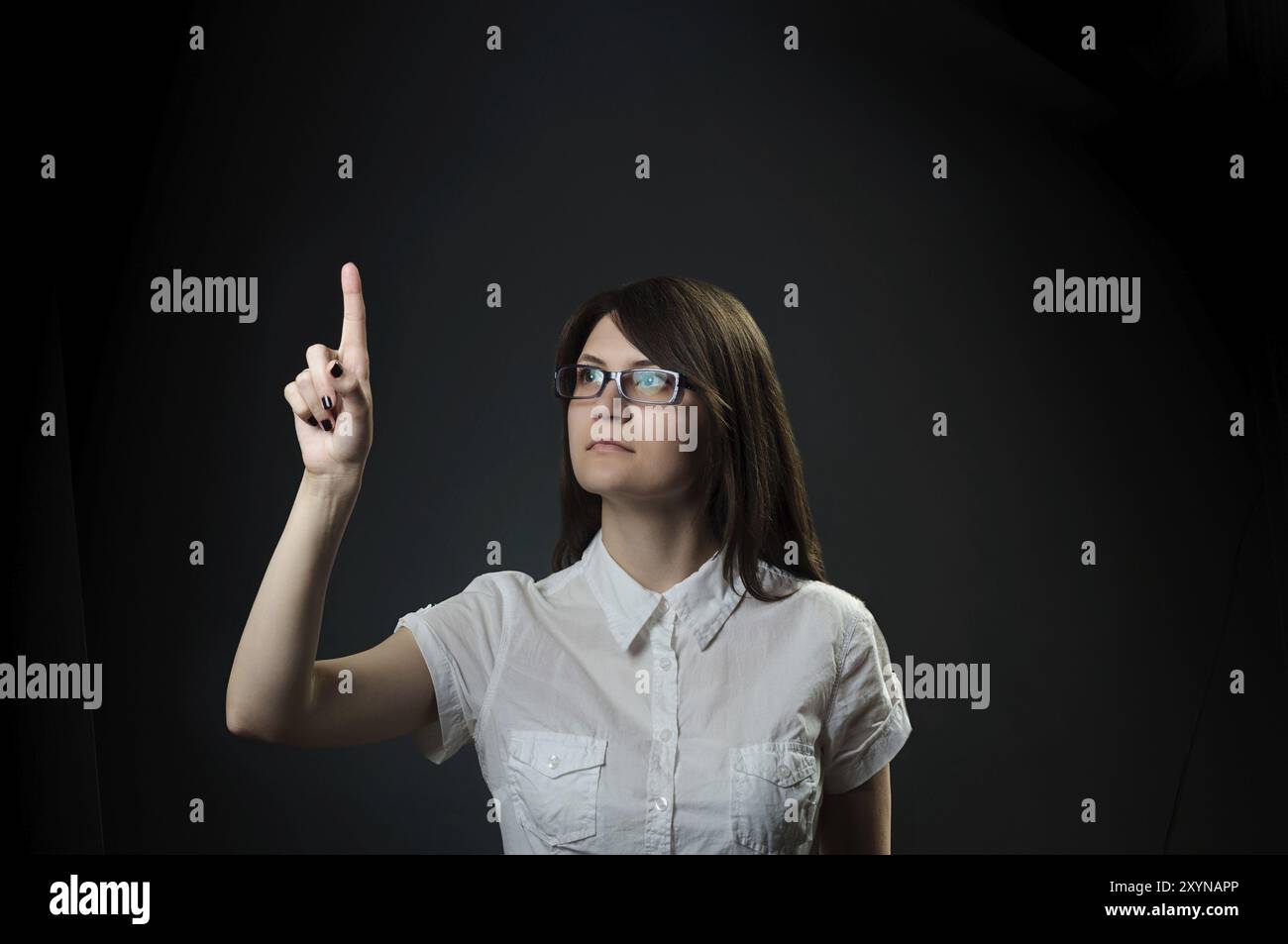 Push Over Computer Brunette woman push computer virtual button with finger over black ...