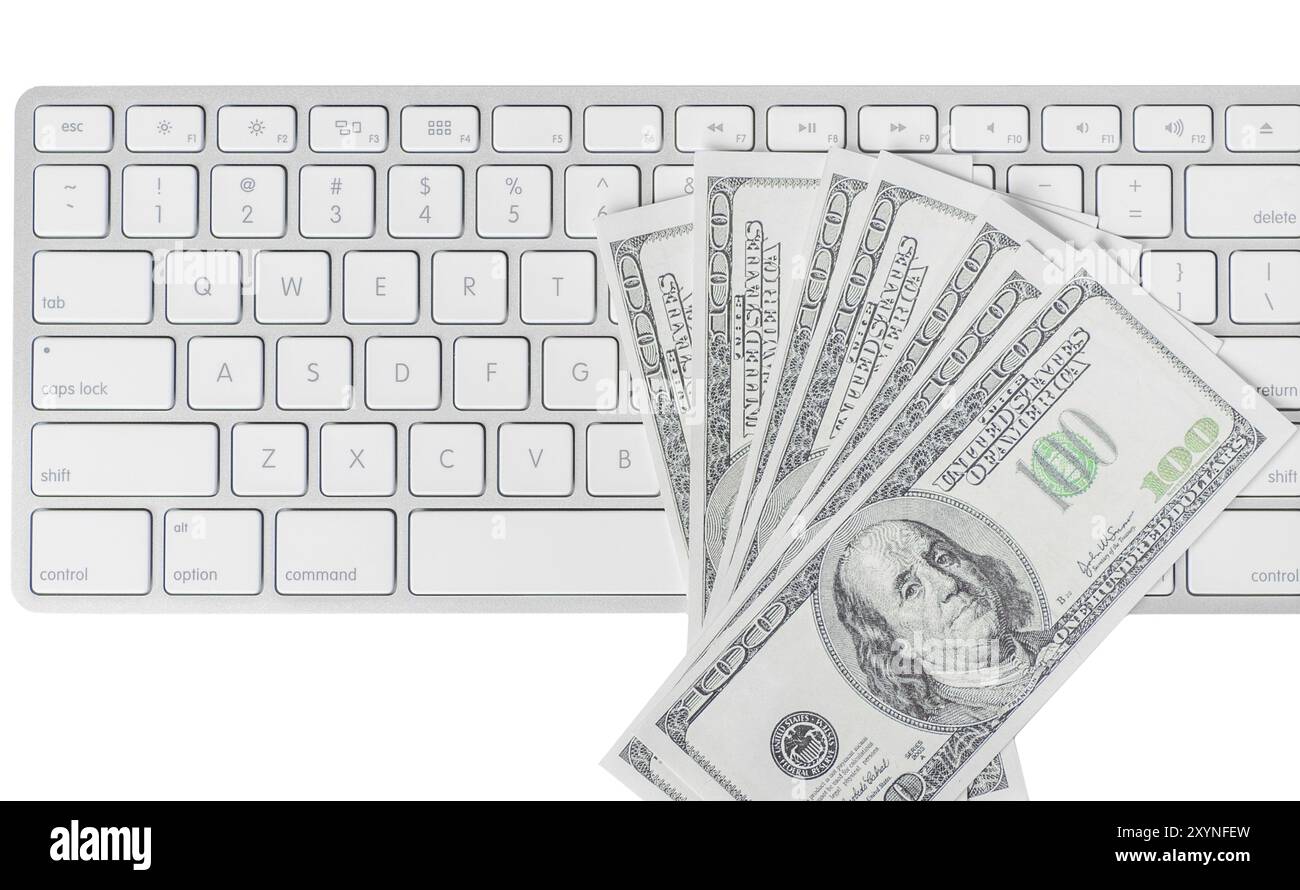 US hundred dollar bills with white computer keyboard isolated on white ...