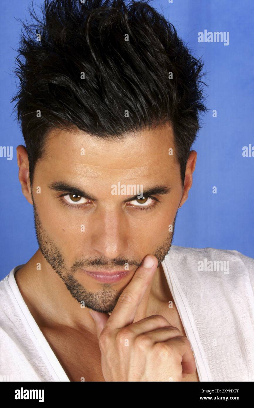 Serious handsome 30 years old man over blue background Stock Photo - Alamy