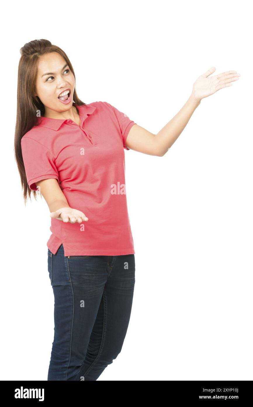 Smiling spokesmodel Asian female in casual clothes, hands, arms out to side, body language presenting, displaying or drawing attention to an off scree Stock Photo