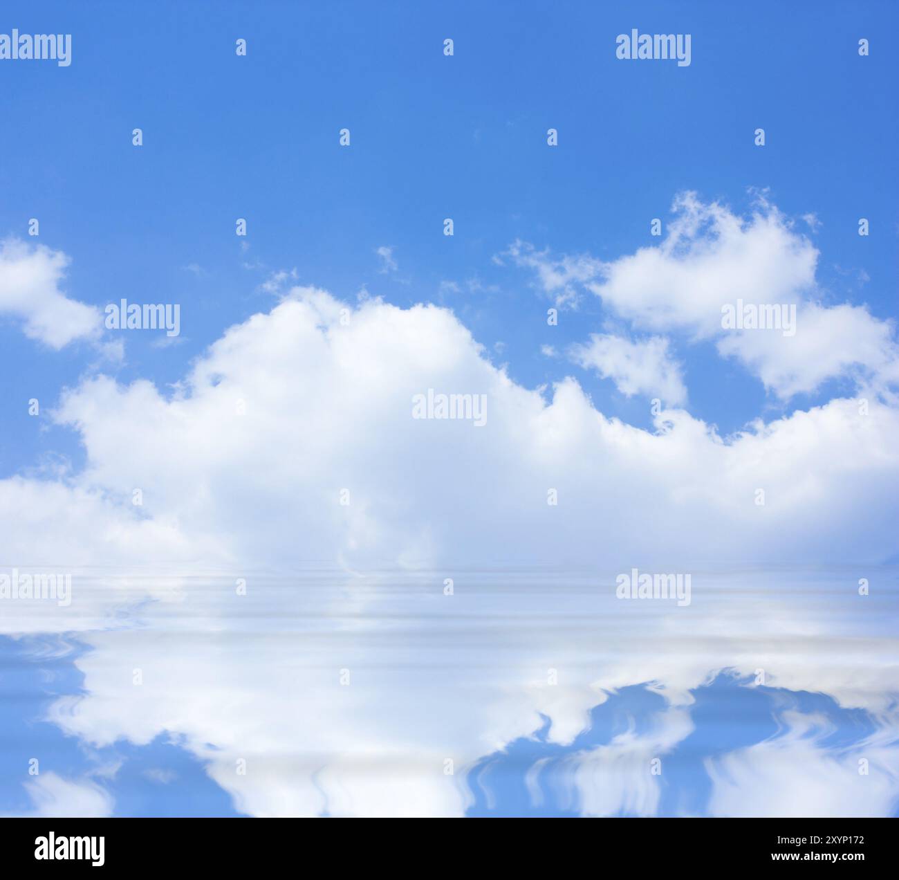 Blue sky with clouds reflected in the water Stock Photo - Alamy
