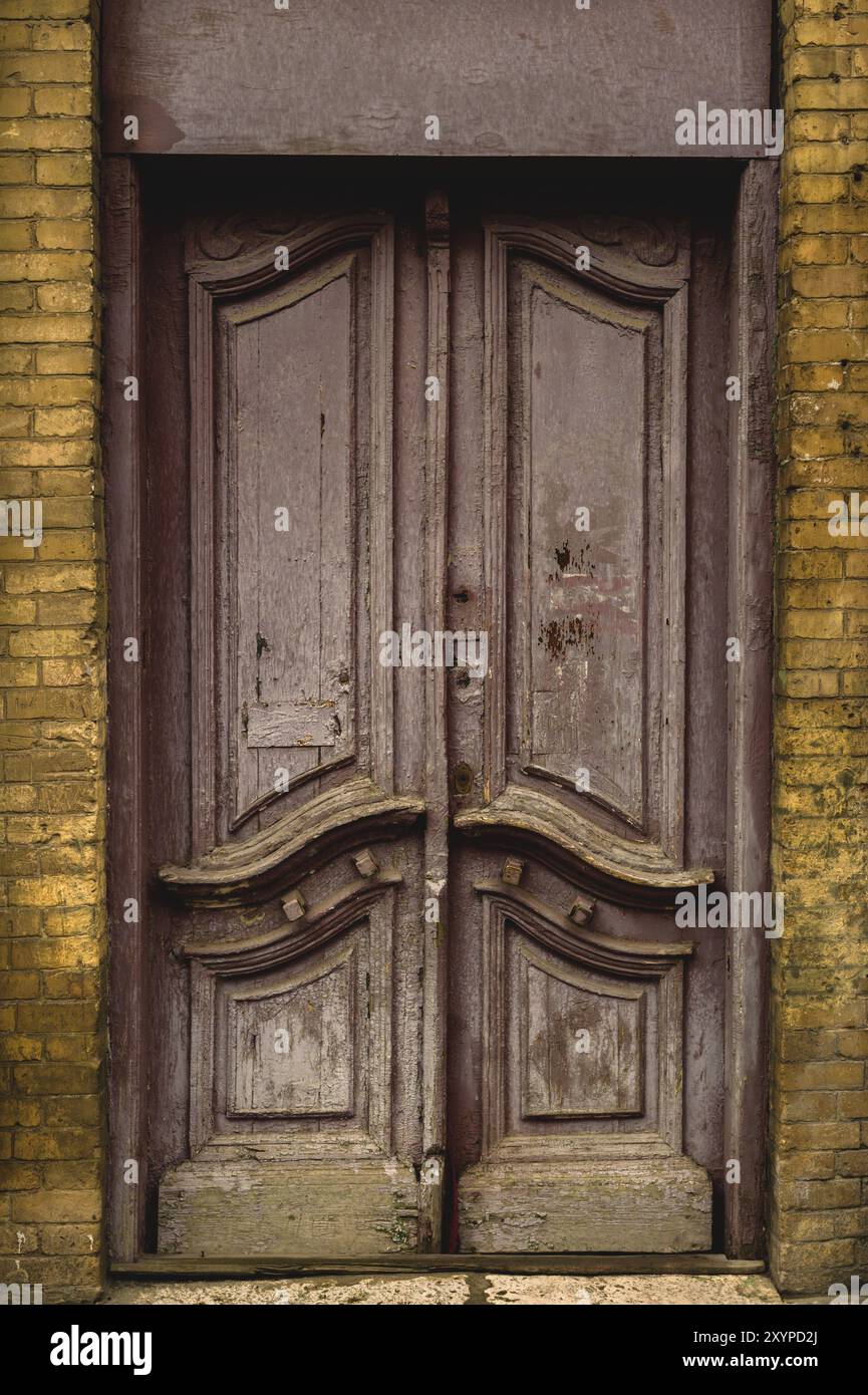 Wooden ancient Italian door in the historic center. Old European architecture. Two-fold wooden carved door. Vintage concept in architecture Stock Photo