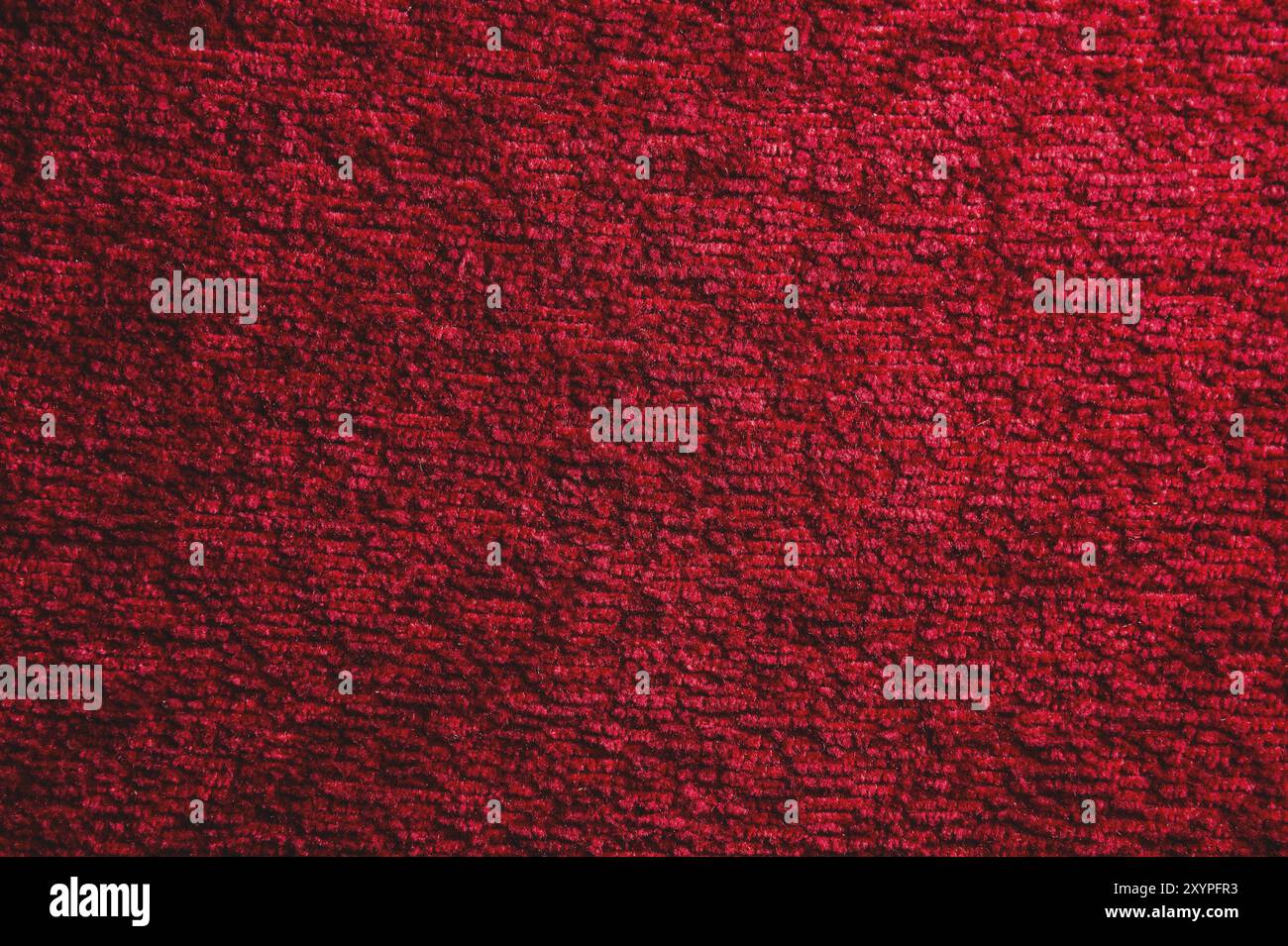 Texture of a dark red carpet. Close-up of gradient light Stock Photo