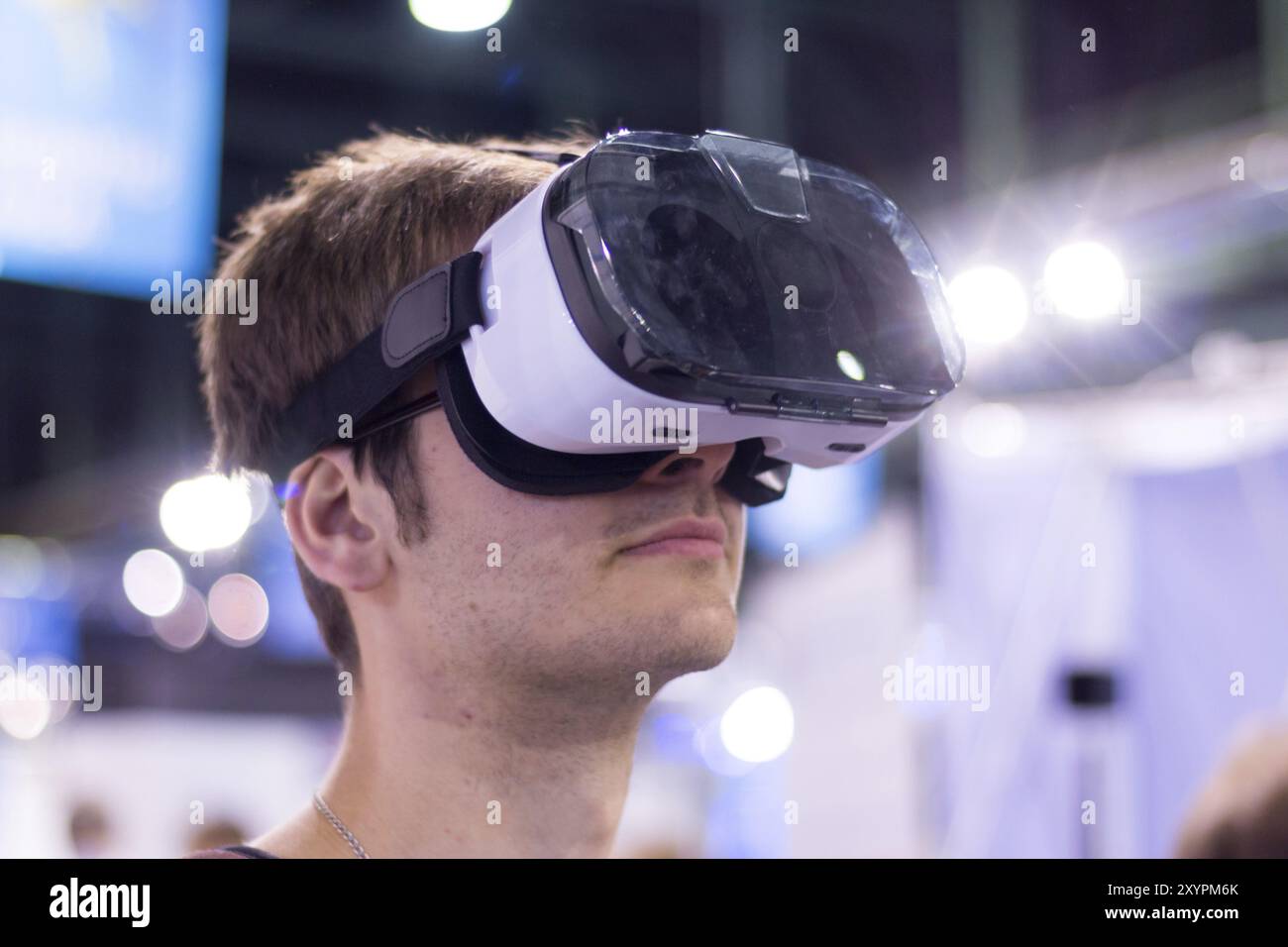 Young man is using virtual reality glasses on an expo Stock Photo