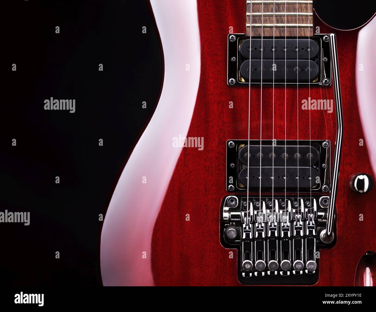 Closeup of red electric guitar Ibanez S-series S420, tremolo and