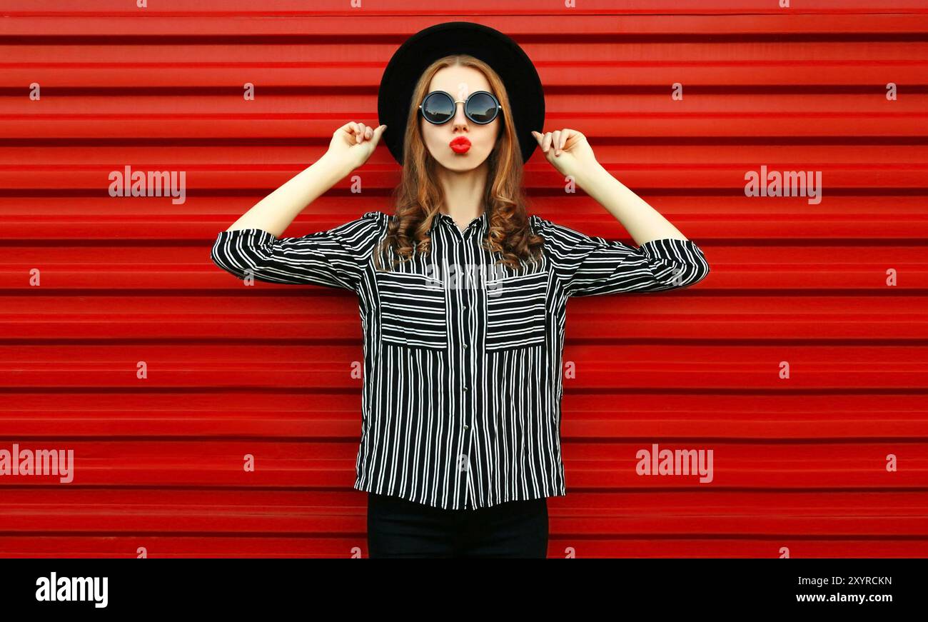 Portrait woman model wearing a black white striped shirt, round hat ...