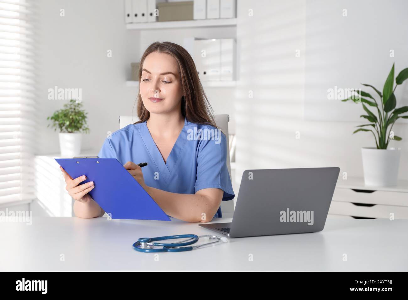Young caregiver in blue scrubs hi-res stock photography and images - Alamy