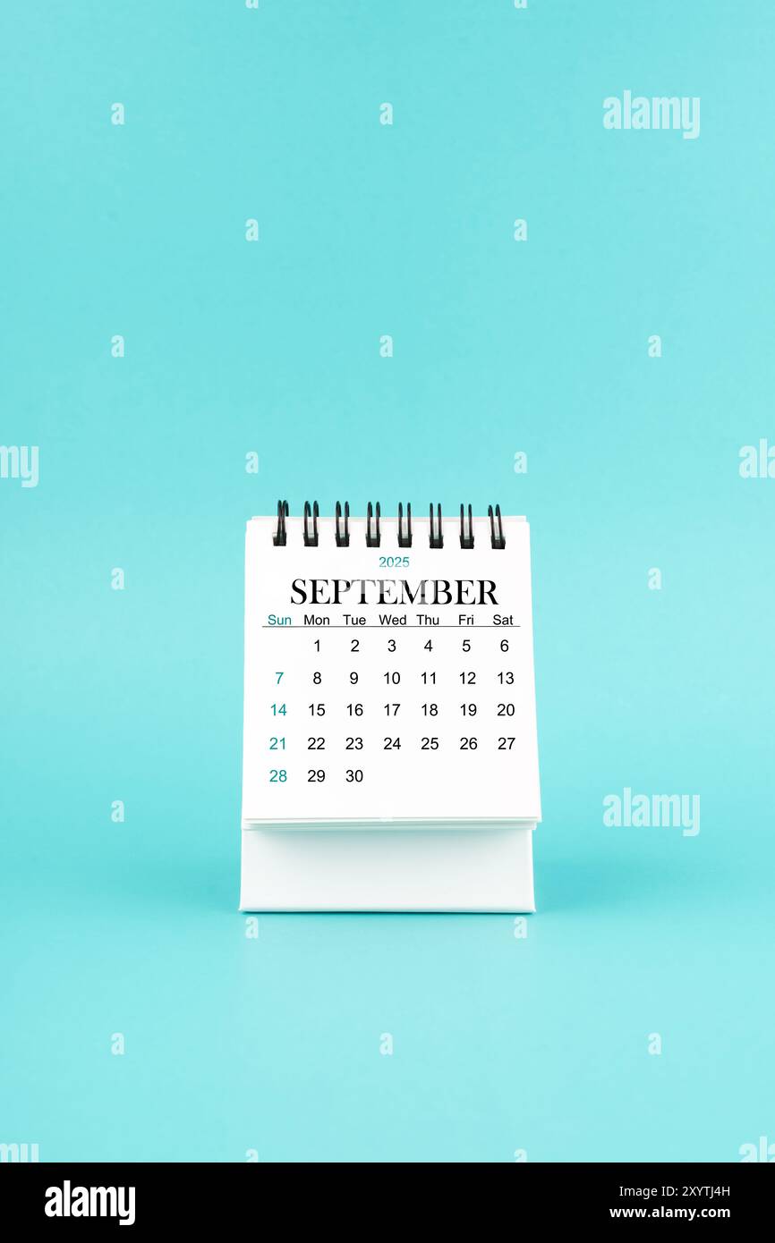 september-2025-white-desk-calendar-on-blue-color-background-stock-photo-alamy