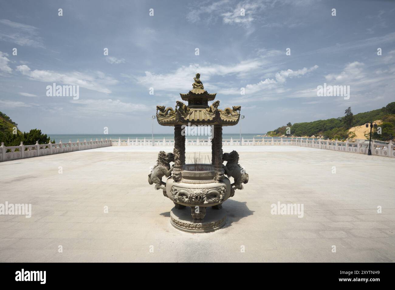 The courtyard at Matsu temple faces out to the ocean with an ornately carved incense urn Stock Photo