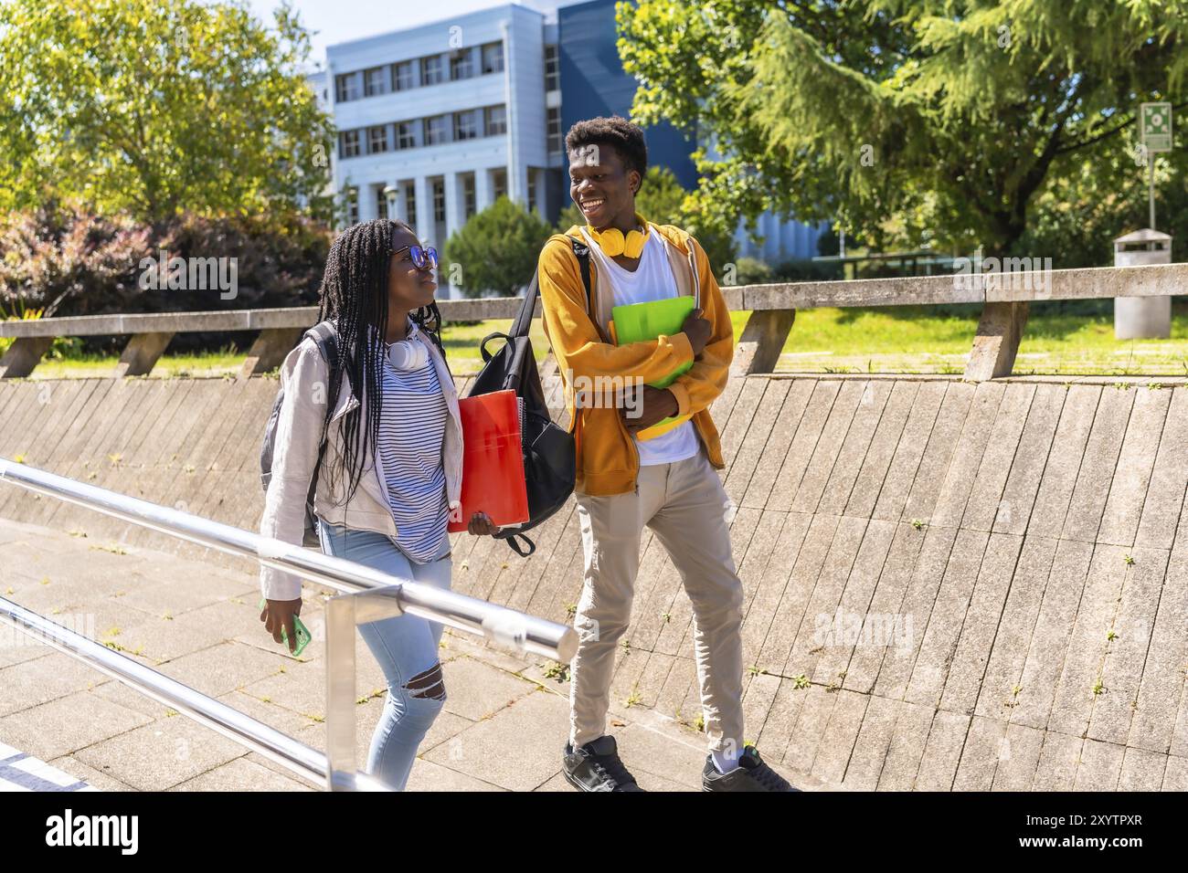 Side view full length of two African american students strolling and ...